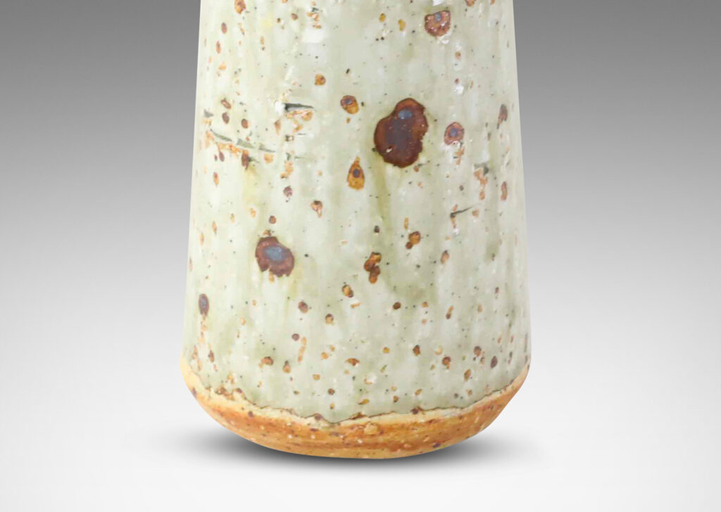 Gallery BAC tall raked cylindrical form with flared lip in a shiny gray-green glaze with brown speckles