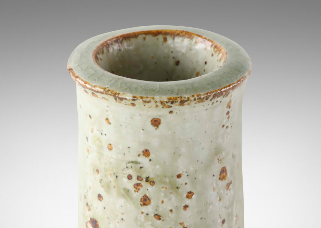 Gallery BAC tall raked cylindrical form with flared lip in a shiny gray-green glaze with brown speckles