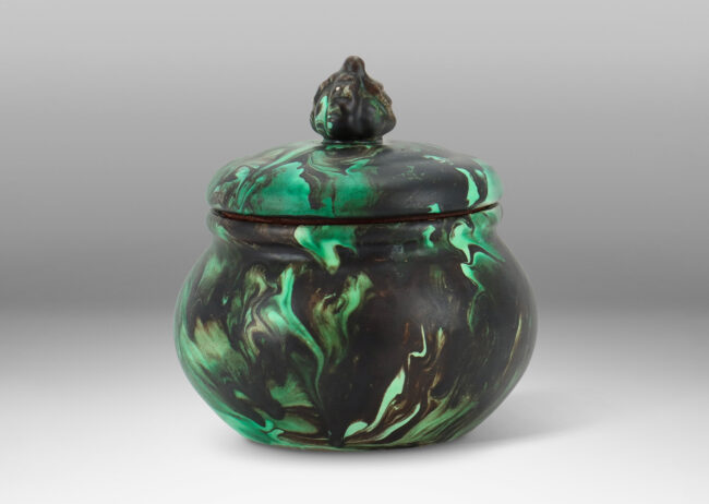 Gallery BAC undulating form with flower-topped finial in marbelized green and black matte glaze