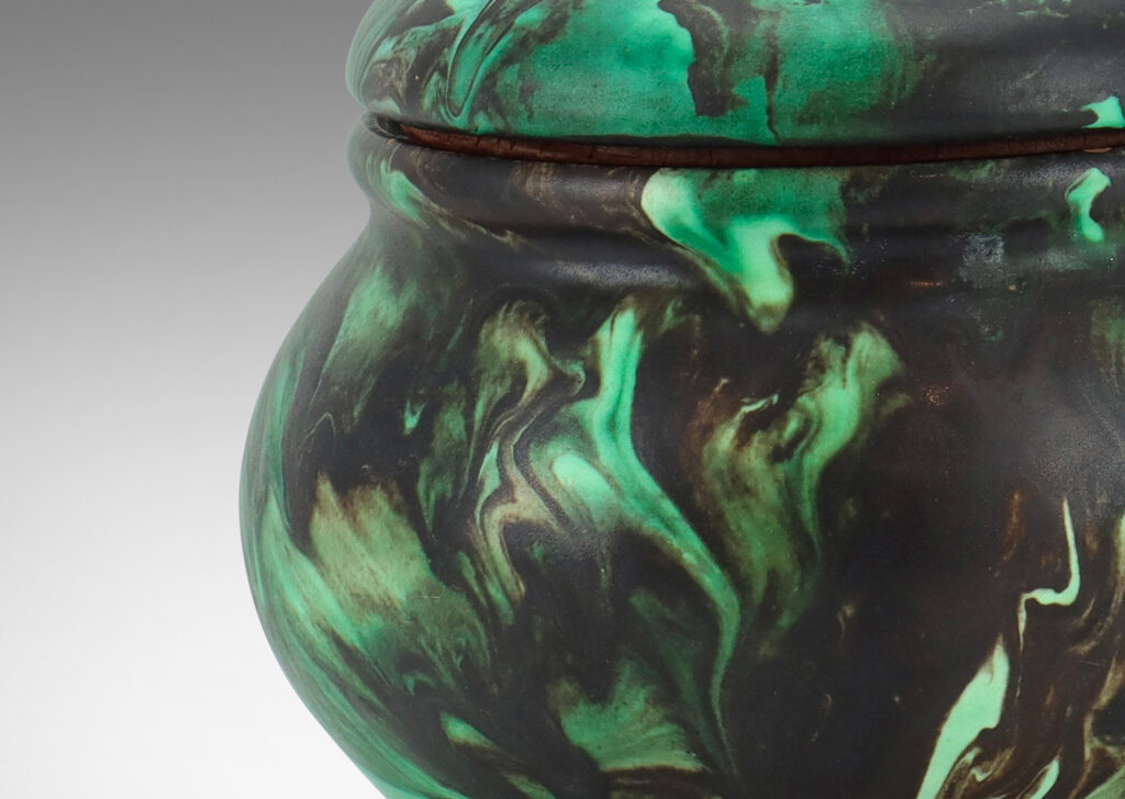 Gallery BAC undulating form with flower-topped finial in marbelized green and black matte glaze