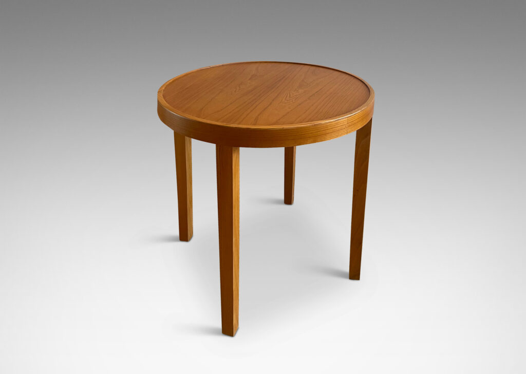 Gallery BAC ound top with four elegantly tapered legs crafted in elm