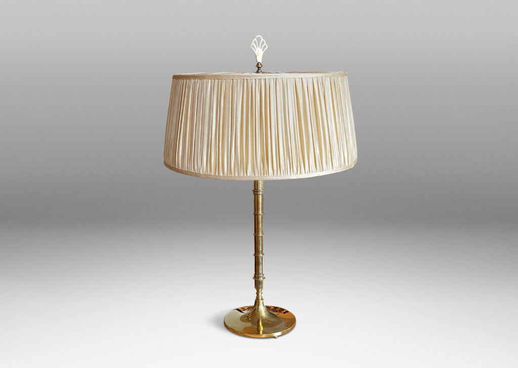 Gallery BAC slender brass stand with bamboo-like decorative rings, two horizontal sockets, and a finial that serves as the switch