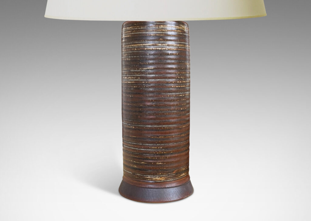 Gallery BAC ridged cylindrical form glazed in a warm brown and pale gray “Sung” glaze with matte brown angled plinth