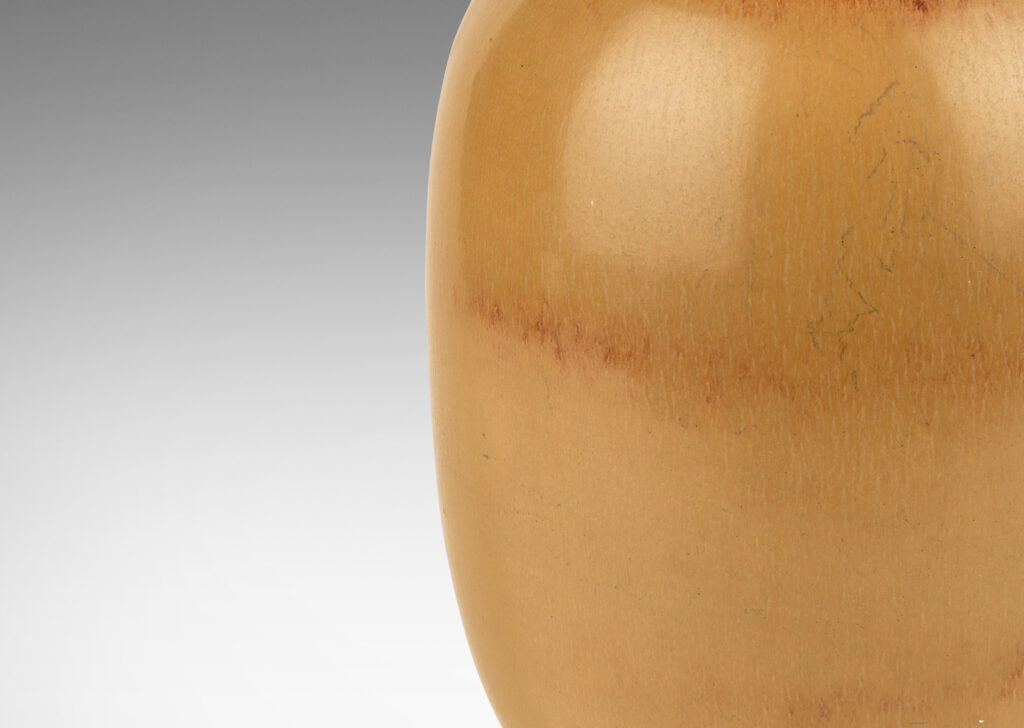 Gallery BAC ovoid form with stem-like neck with leaves, glazed in tan tones with terra cotta accents