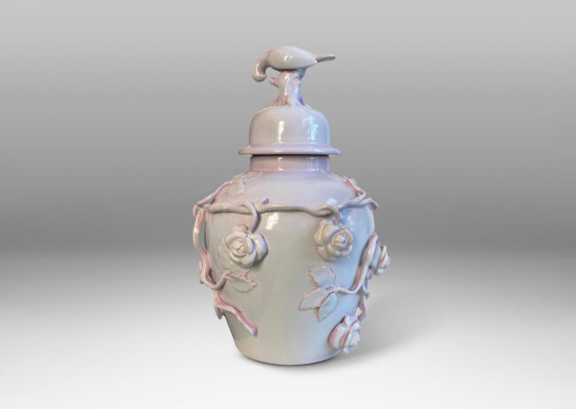 Gallery BAC lid with branch and bird finial, and surrounding climbing rose reliefs, glazed in a soft rose-lavender