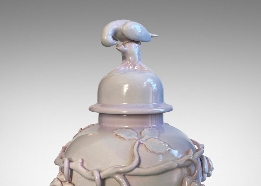 Gallery BAC lid with branch and bird finial, and surrounding climbing rose reliefs, glazed in a soft rose-lavender