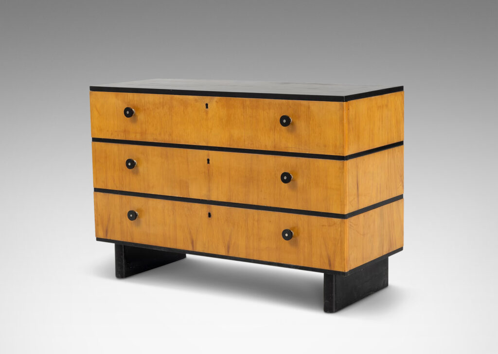 Gallery BAC three drawers in blonde birch stacked between thin ebonized bands, with ebonized pulls, top and pier legs