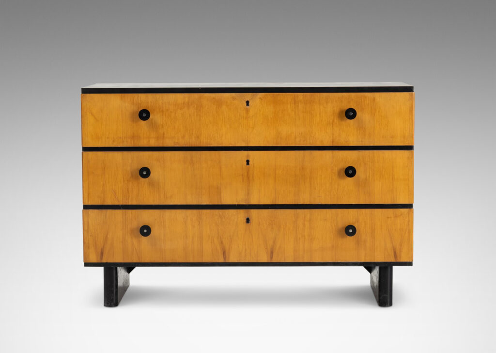 Gallery BAC three drawers in blonde birch stacked between thin ebonized bands, with ebonized pulls, top and pier legs