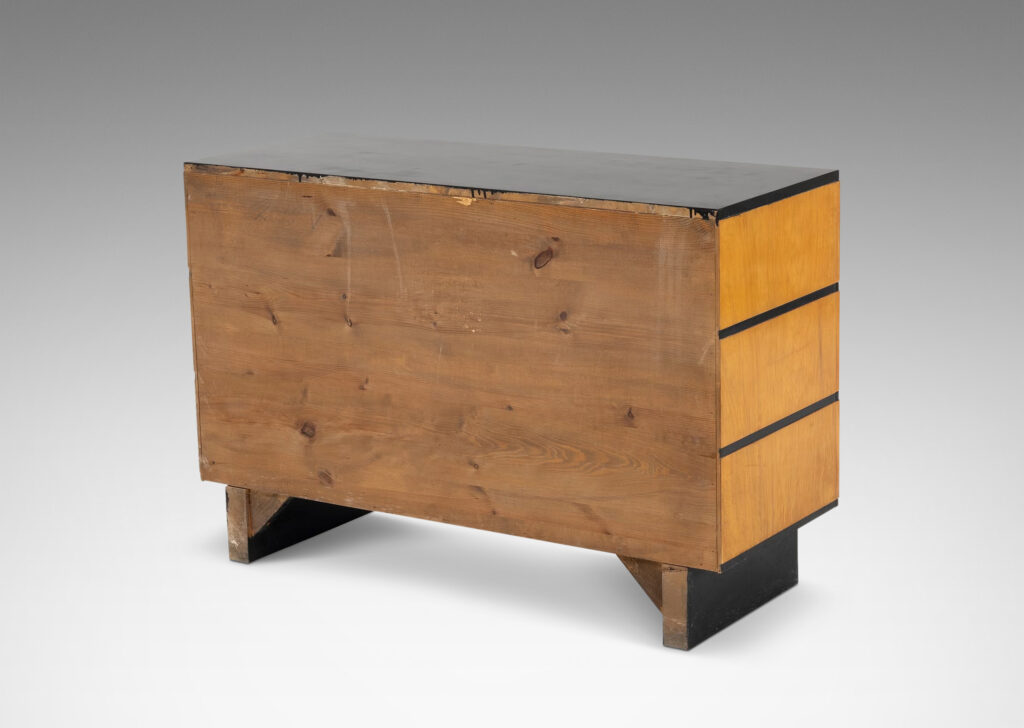 Gallery BAC three drawers in blonde birch stacked between thin ebonized bands, with ebonized pulls, top and pier legs