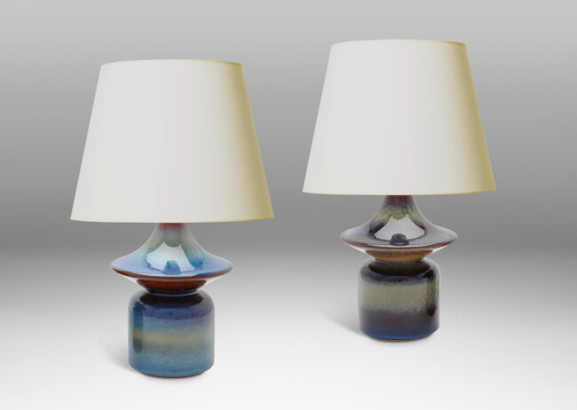 Gallery BAC pawn-like forms with wide saucer finials, glazed in a lustrous blue with brown accents