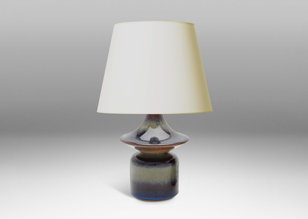 Gallery BAC pawn-like forms with wide saucer finials, glazed in a lustrous blue with brown accents