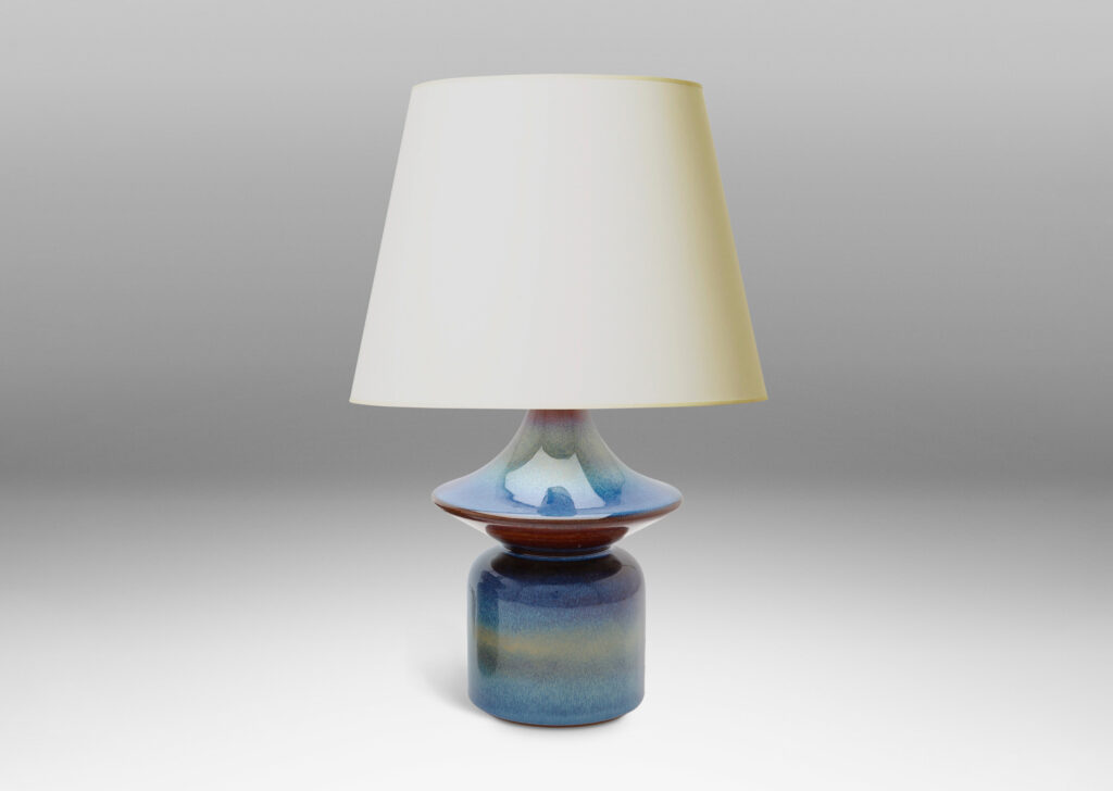 Gallery BAC pawn-like forms with wide saucer finials, glazed in a lustrous blue with brown accents