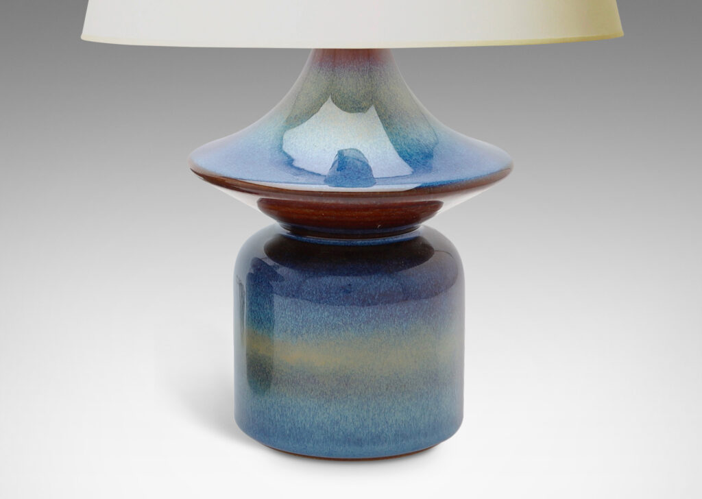 Gallery BAC pawn-like forms with wide saucer finials, glazed in a lustrous blue with brown accents