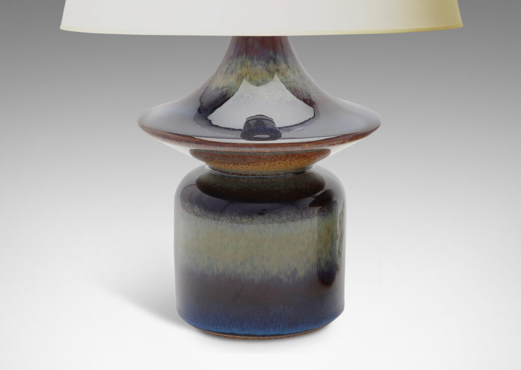 Gallery BAC pawn-like forms with wide saucer finials, glazed in a lustrous blue with brown accents