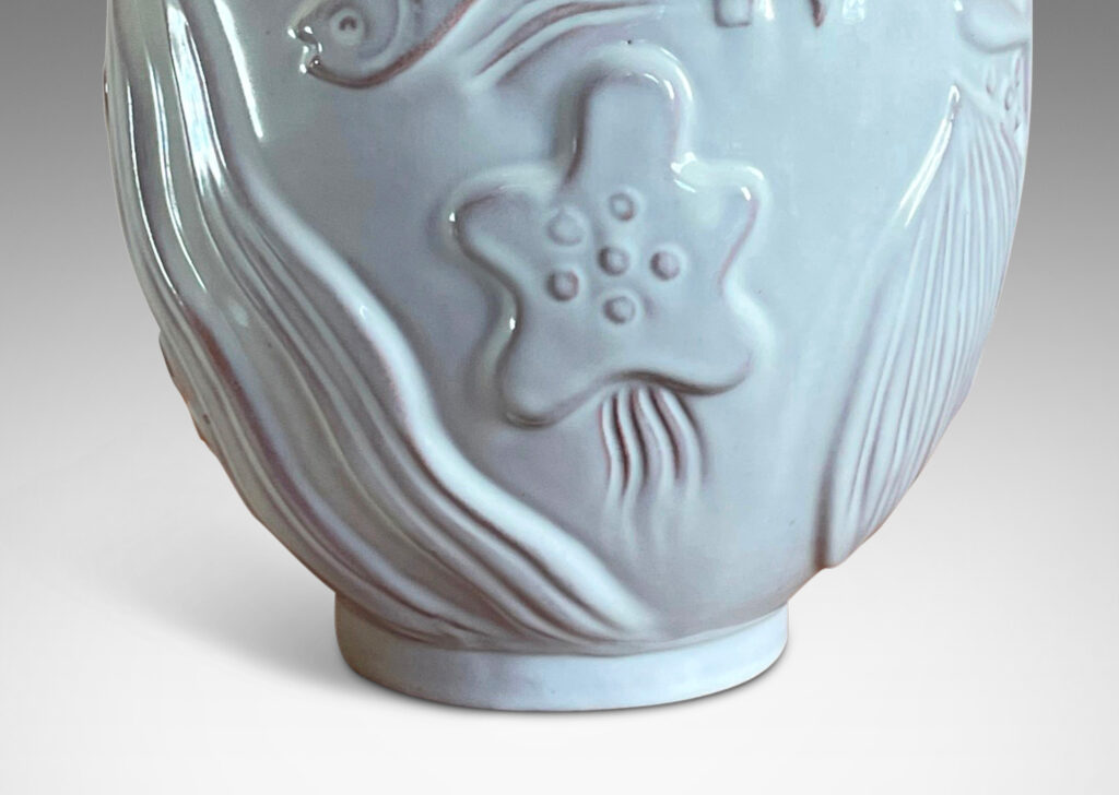 Gallery BAC arge ovoid form surrounded in reliefs depicting marine life, glazed in a shiny off-white