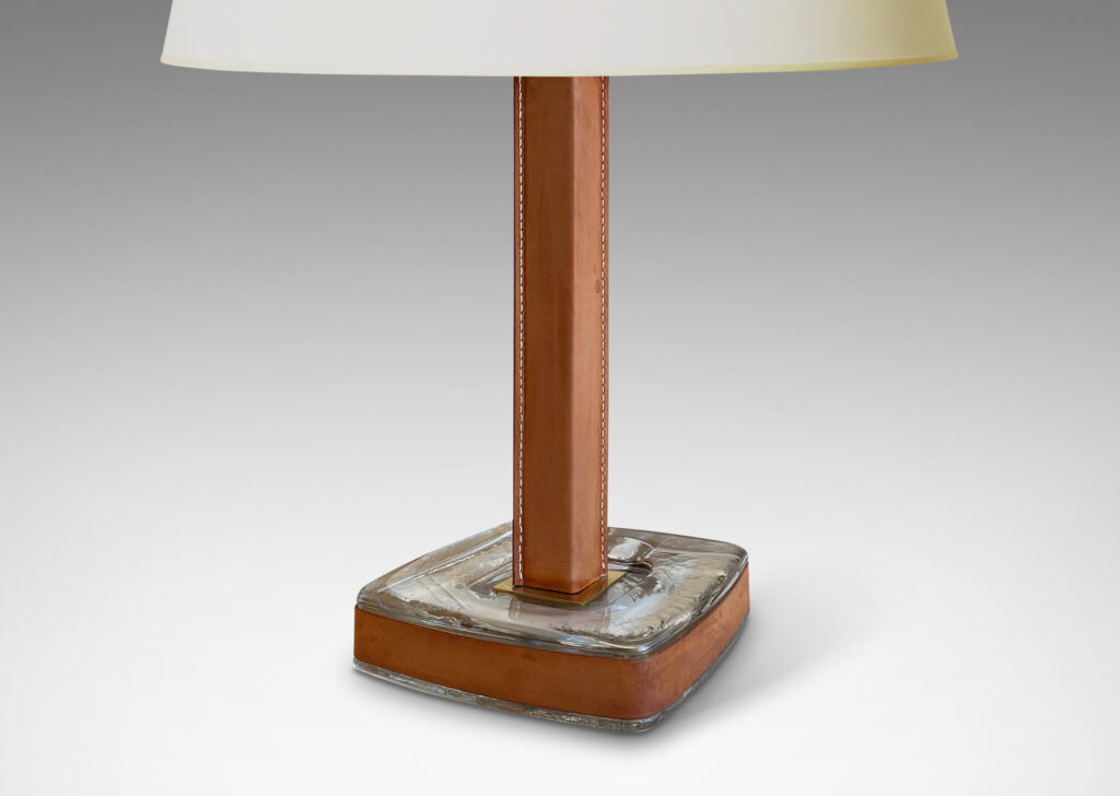 Gallery BAC stand in brass, partially covered in stitched unfinished tan leather, with a hand-formed crystal base