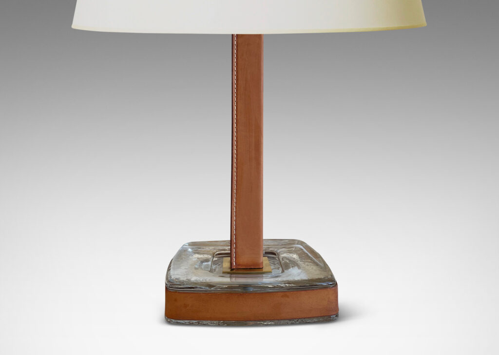 Gallery BAC stand in brass, partially covered in stitched unfinished tan leather, with a hand-formed crystal base