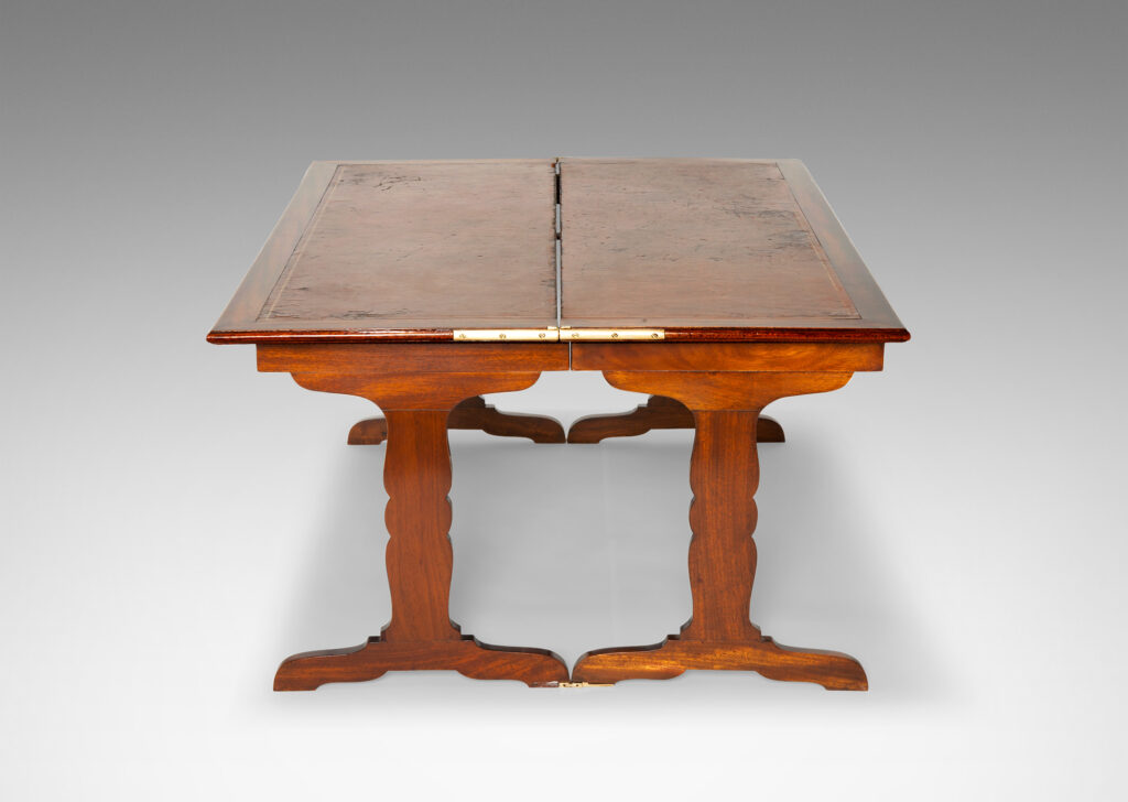 Gallery BAC “tric-trac” folding mechanism that doubles the table’s size, with cut-out style legs in the Regency taste and original leather insets on top