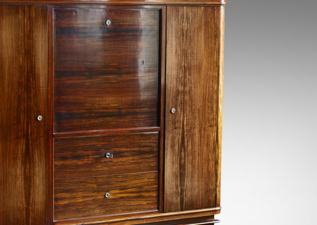 Gallery BAC rosewood and with brass mounts with drop front secretaire finished internally in maple, flanked by two cabinets and with three drawers beneath