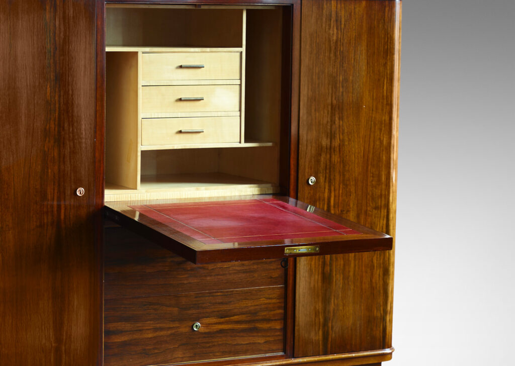 Gallery BAC rosewood and with brass mounts with drop front secretaire finished internally in maple, flanked by two cabinets and with three drawers beneath