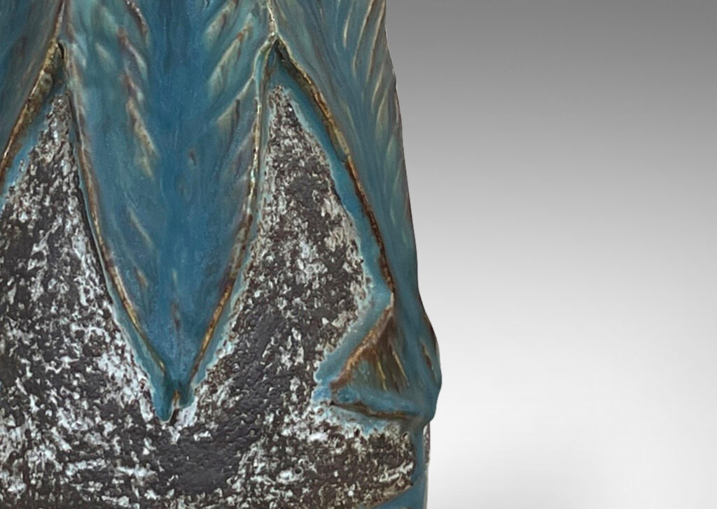 Gallery BAC aceted conical form, with robustly carved leafy forms glazed incornflower blue