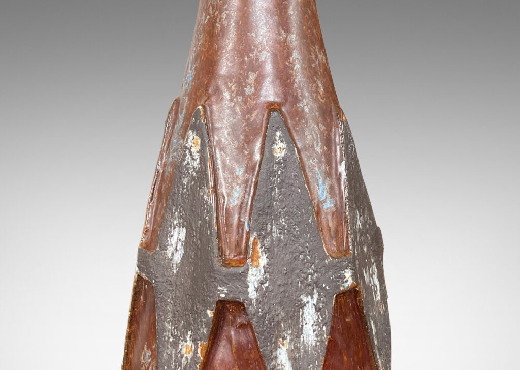 Gallery BAC conical form with relief harlequin ornaments, glazed in dark gray against brown