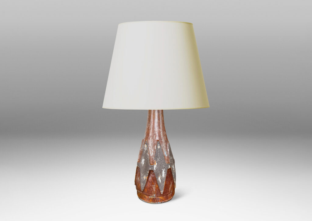 Gallery BAC conical form with relief harlequin ornaments, glazed in dark gray against brown