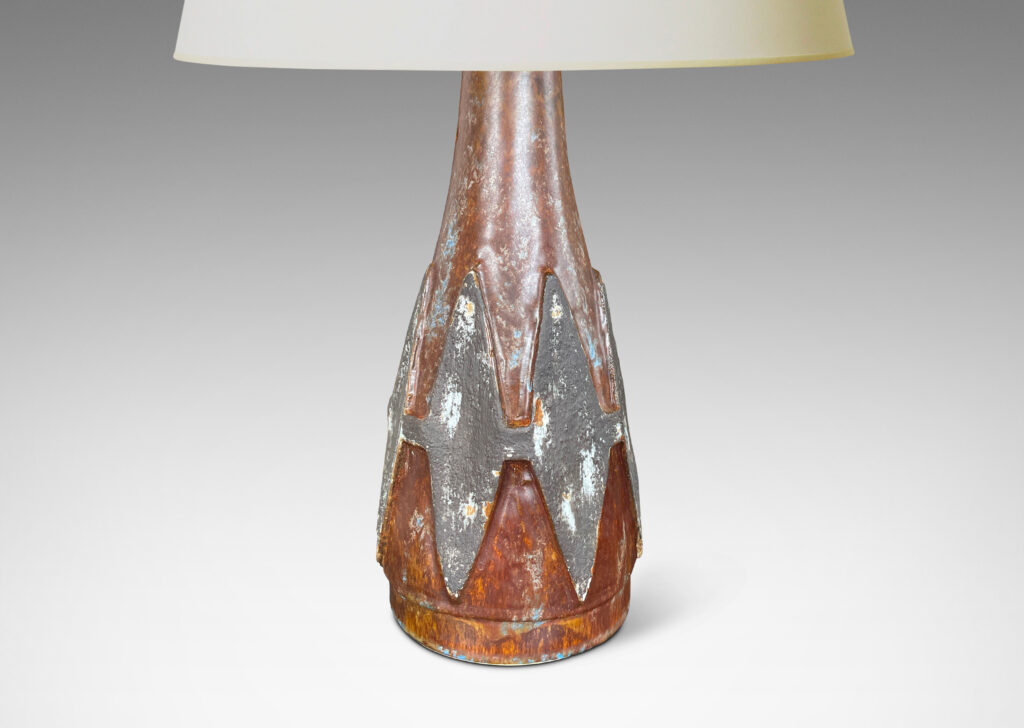 Gallery BAC conical form with relief harlequin ornaments, glazed in dark gray against brown