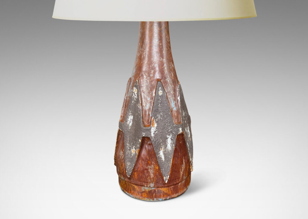 Gallery BAC conical form with relief harlequin ornaments, glazed in dark gray against brown