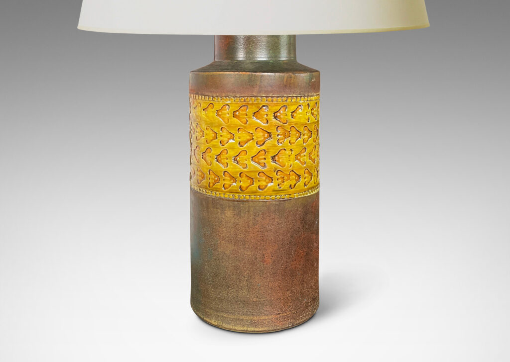 Gallery BAC canister form in matte green-brown, with wide bands with impressed ornaments glazed in a gloss golden tone