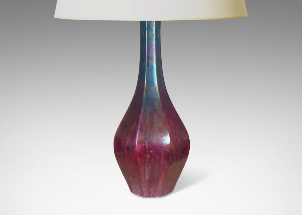 Gallery BAC octagonally-faceted decanter form with attenuated neck, glazed in berry red and teal luster