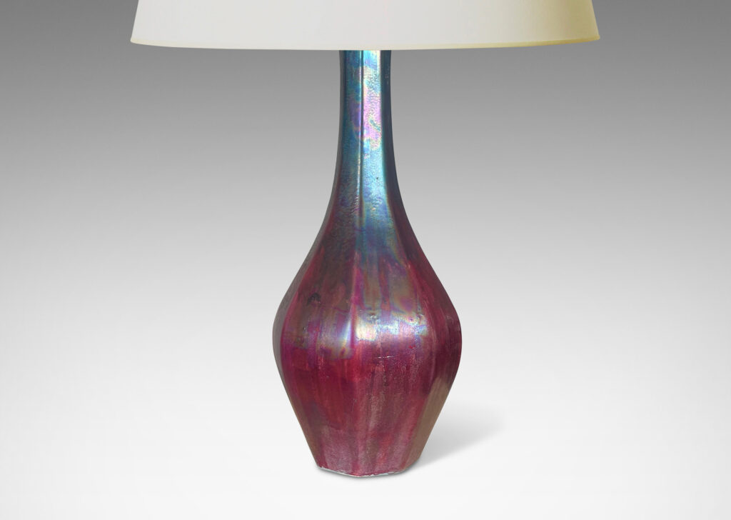 Gallery BAC octagonally-faceted decanter form with attenuated neck, glazed in berry red and teal luster