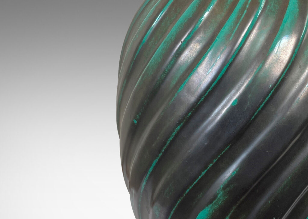 Gallery BAC fluted upright oval forms with vertical fluting; ceramic with a deep teal copper oxide glaze