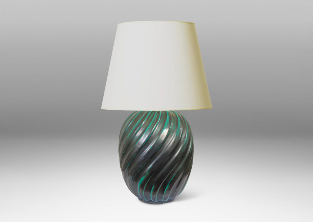 Gallery BAC fluted upright oval forms with vertical fluting; ceramic with a deep teal copper oxide glaze