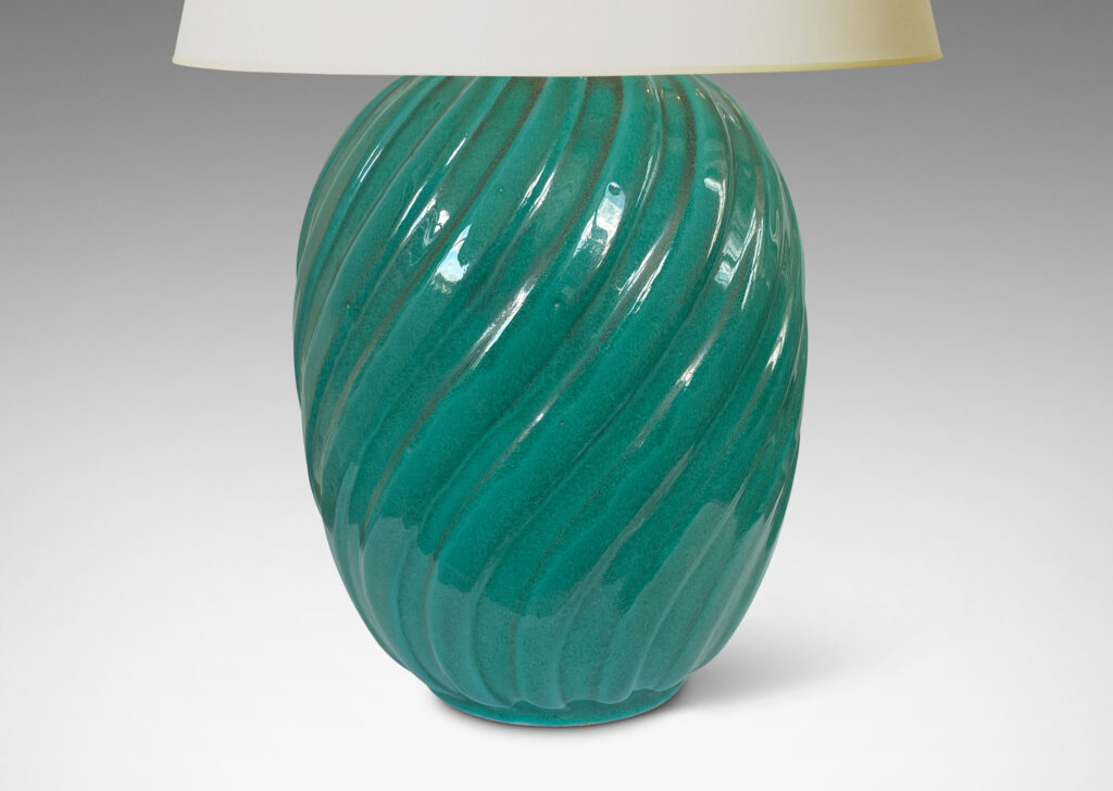 Gallery BAC fluted upright oval forms with vertical fluting; ceramic with a deep teal copper oxide glaze