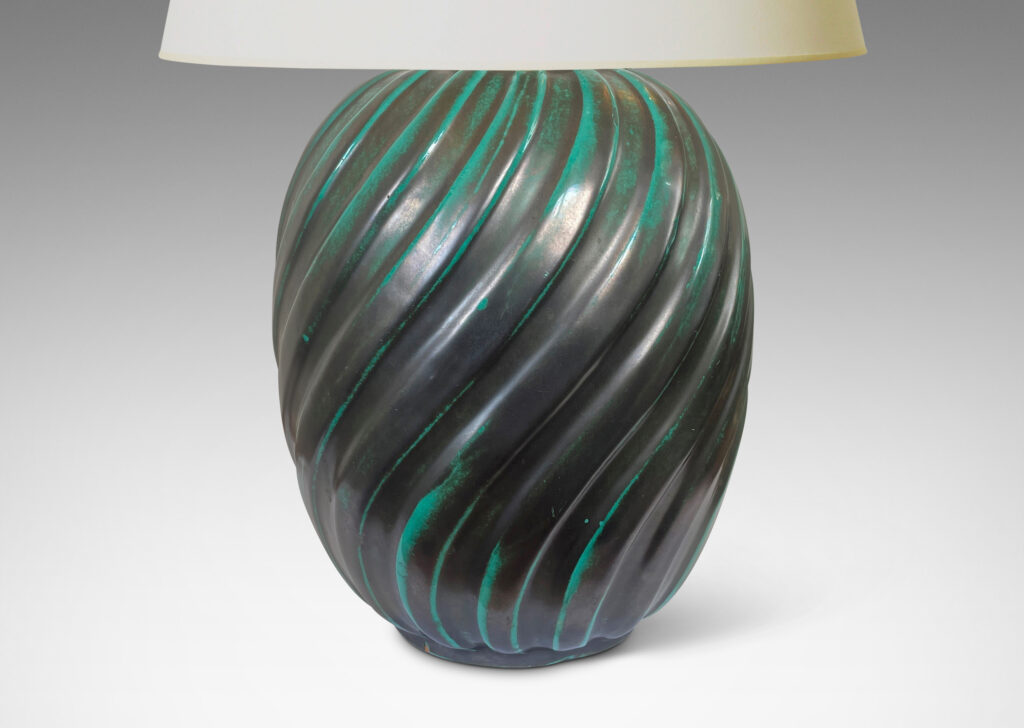 Gallery BAC fluted upright oval forms with vertical fluting; ceramic with a deep teal copper oxide glaze