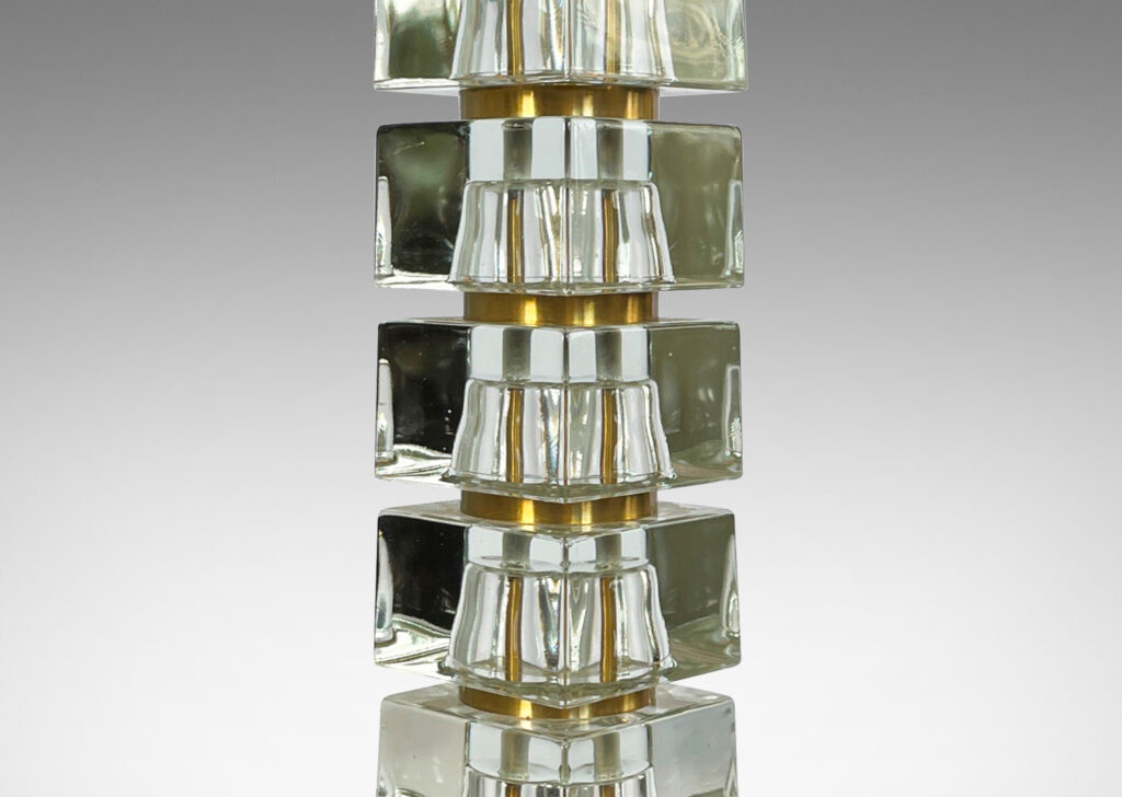 Gallery BAC consisting of stacked squared clear glass blocks with round brass separators, cast glass with brass