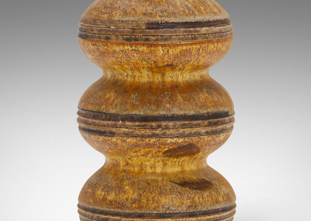 Gallery BAC form of stacked compressed globes with carved bands, glazed in a sponged matte gold-brown