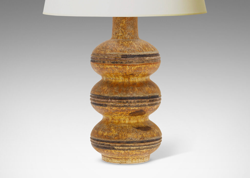 Gallery BAC form of stacked compressed globes with carved bands, glazed in a sponged matte gold-brown