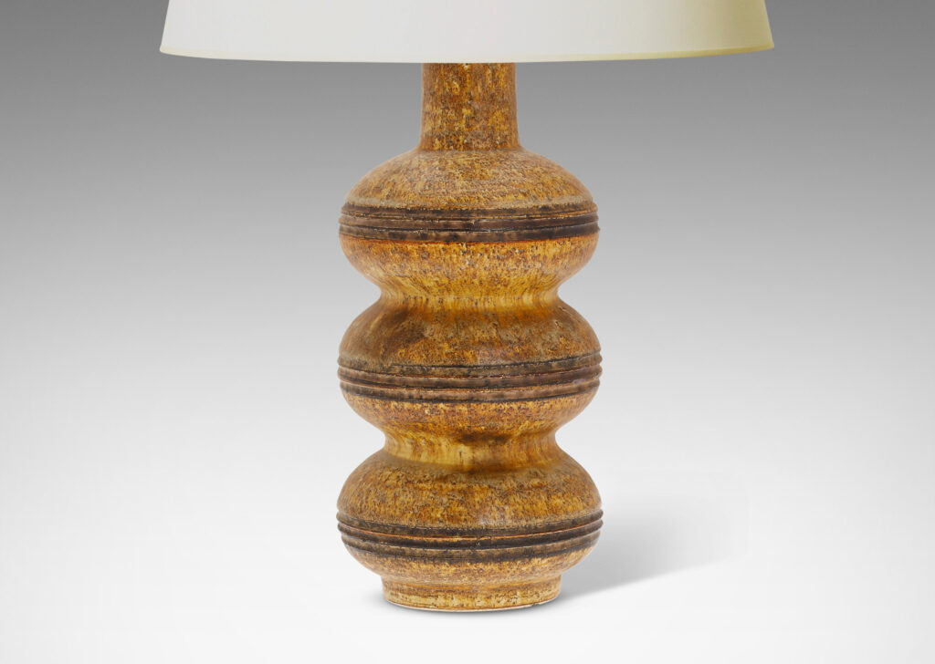 Gallery BAC form of stacked compressed globes with carved bands, glazed in a sponged matte gold-brown