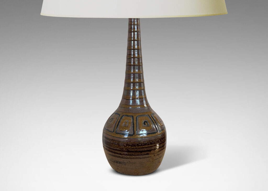 Gallery BAC bulbous form with tall conical neck, glazed in brown luster tones, with pattern of stripes and concentric square motifs