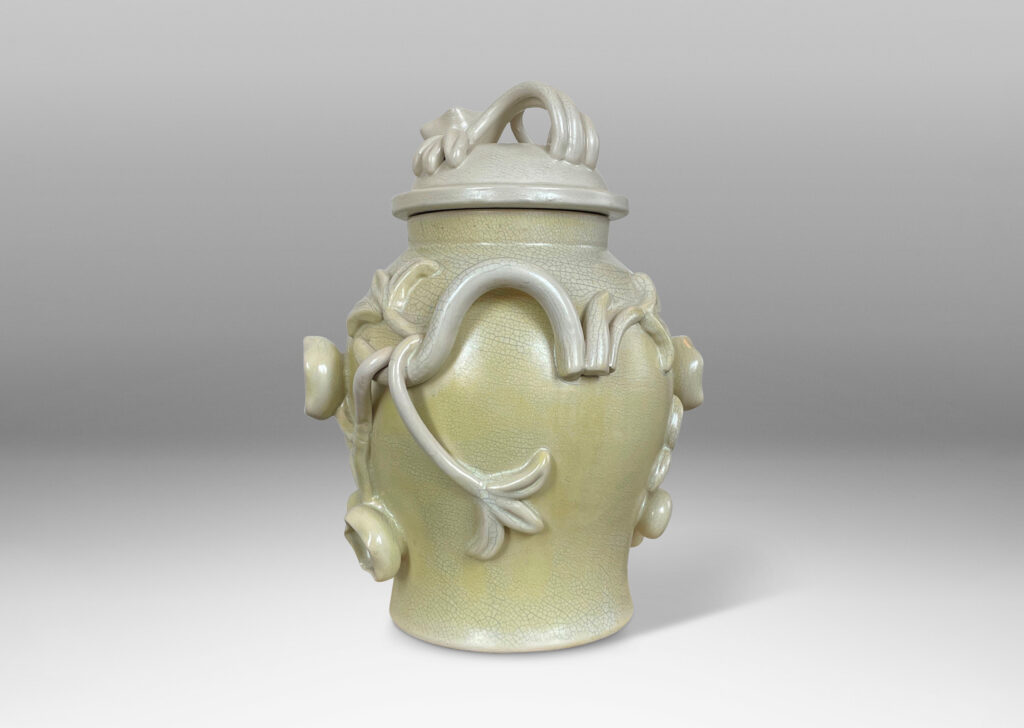 Gallery BAC swelling form with high-relief applied floral reliefs and dome lid, glazed in ivory and lemon yellow