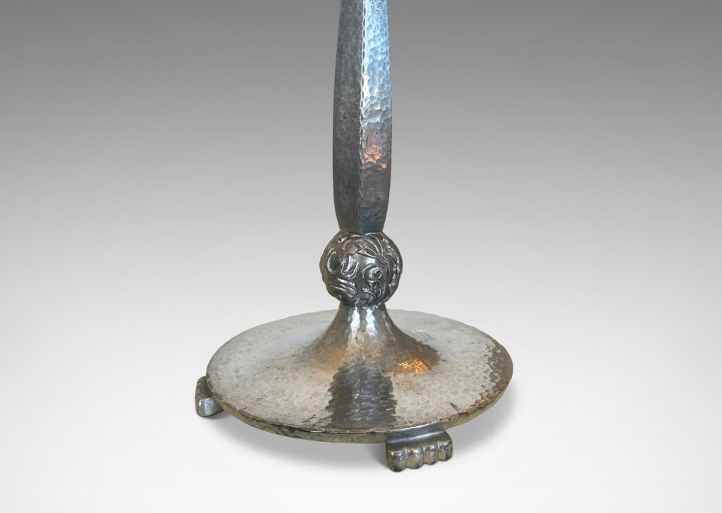 Gallery BAC faceted baluster stand and disk base with a hammered finish, detailed with stylized paw feet and fob with charming bird reliefs