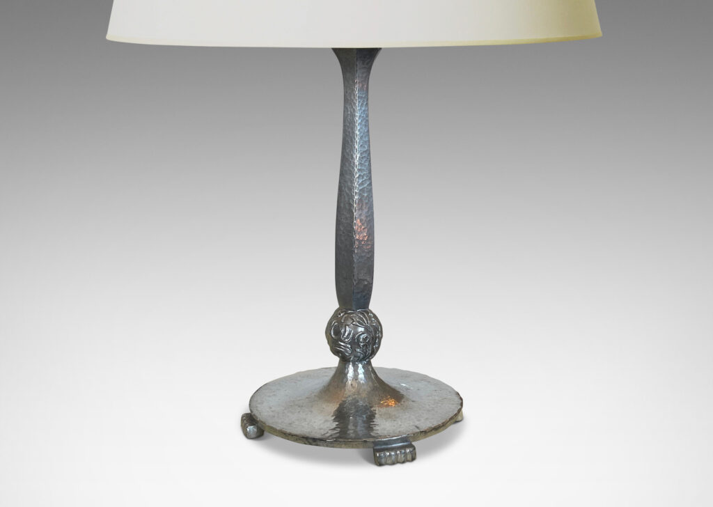 Gallery BAC faceted baluster stand and disk base with a hammered finish, detailed with stylized paw feet and fob with charming bird reliefs