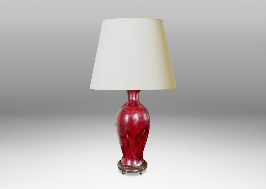 Gallery BAC modeled after a Chinese plum vase form, magnificently finished in deep red flambé glaze with just the right touches of purple and painterly flowing swagging