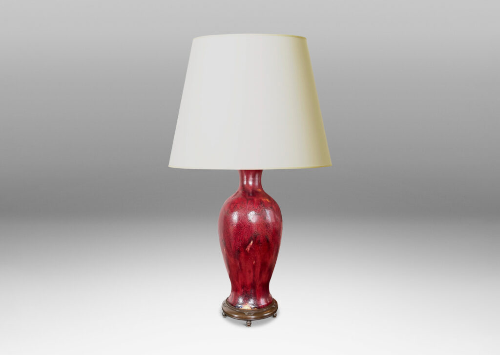 Gallery BAC modeled after a Chinese plum vase form, magnificently finished in deep red flambé glaze with just the right touches of purple and painterly flowing swagging