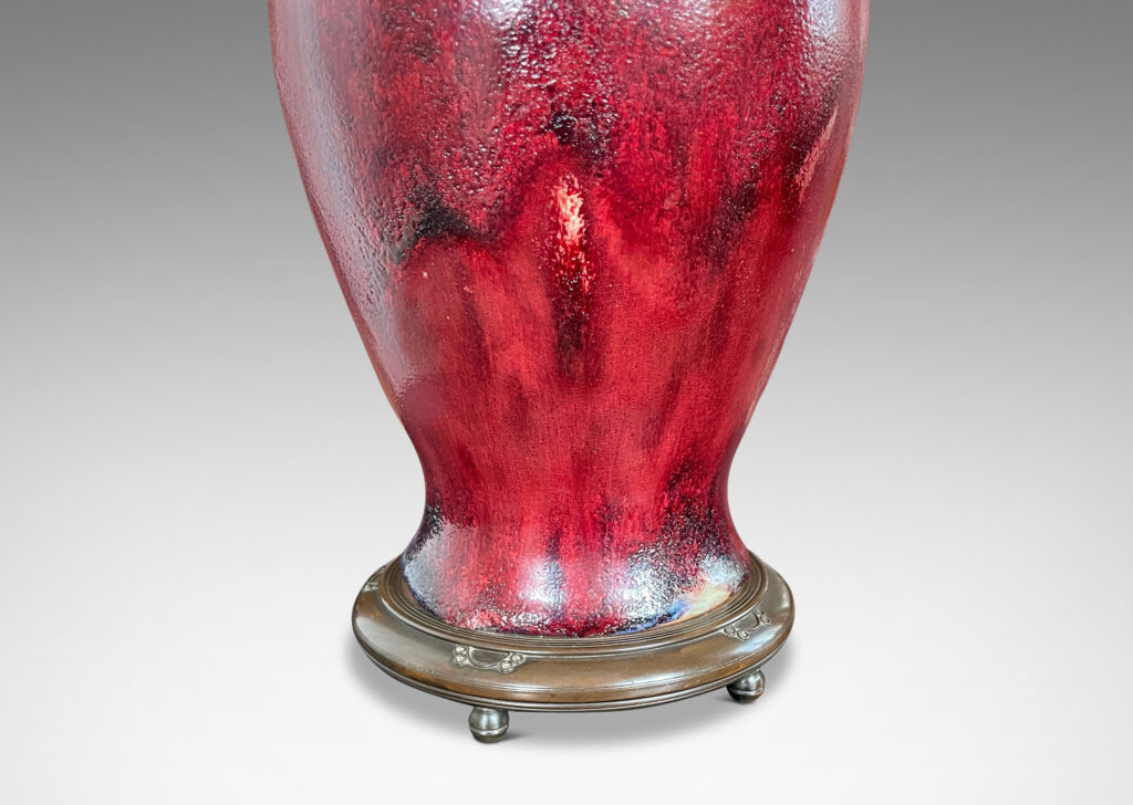 Gallery BAC modeled after a Chinese plum vase form, magnificently finished in deep red flambé glaze with just the right touches of purple and painterly flowing swagging