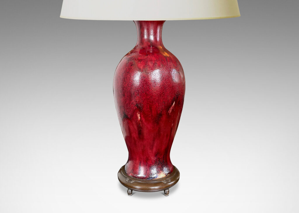 Gallery BAC modeled after a Chinese plum vase form, magnificently finished in deep red flambé glaze with just the right touches of purple and painterly flowing swagging