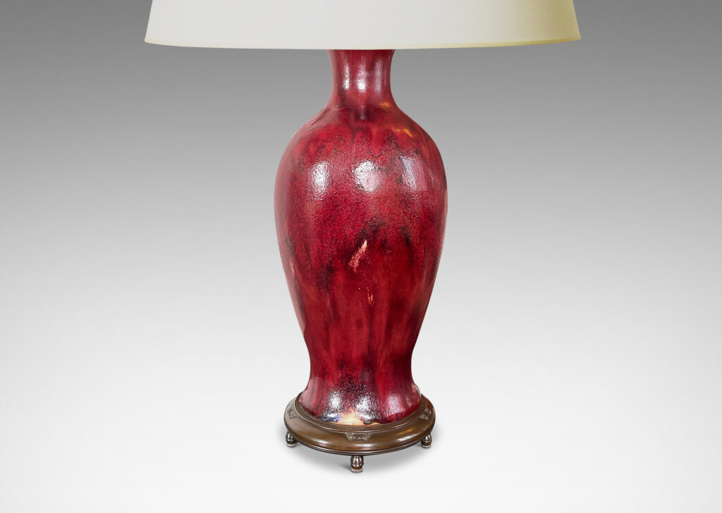 Gallery BAC modeled after a Chinese plum vase form, magnificently finished in deep red flambé glaze with just the right touches of purple and painterly flowing swagging