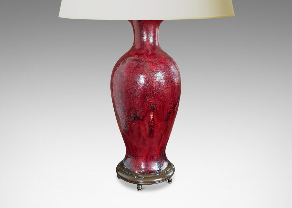 Gallery BAC modeled after a Chinese plum vase form, magnificently finished in deep red flambé glaze with just the right touches of purple and painterly flowing swagging